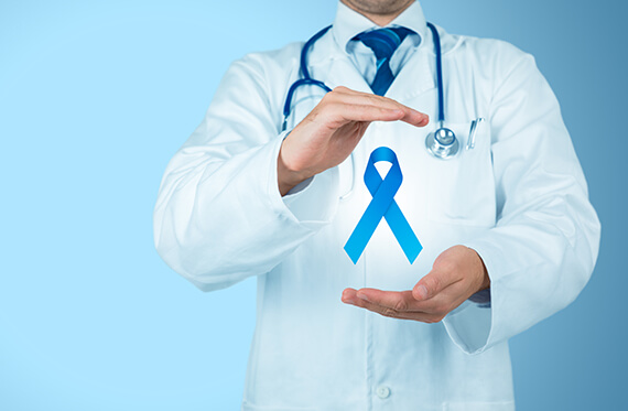 Close up of a doctor's torso as their hands are around a blue ribbon